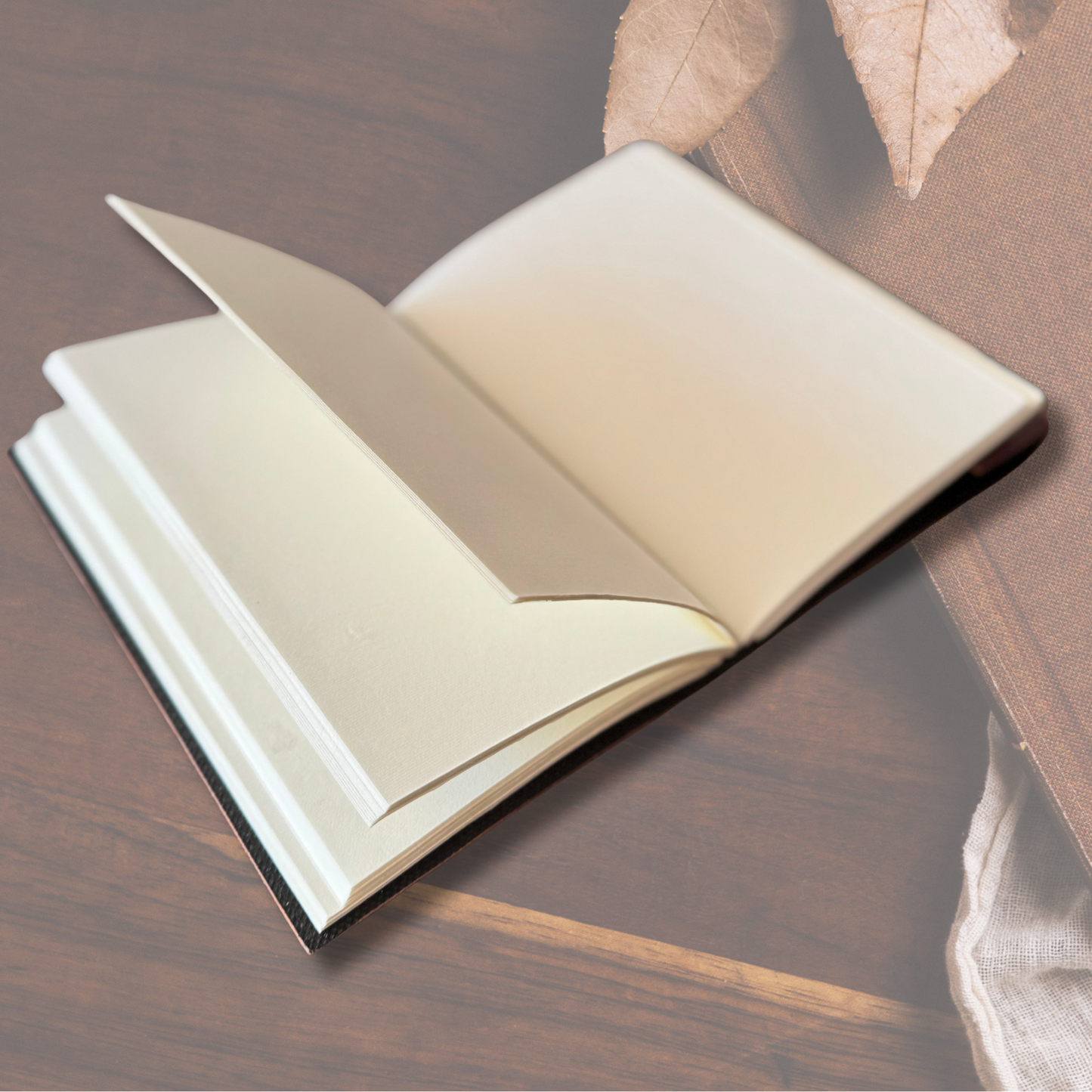 Open leather journal with plain white blank pages