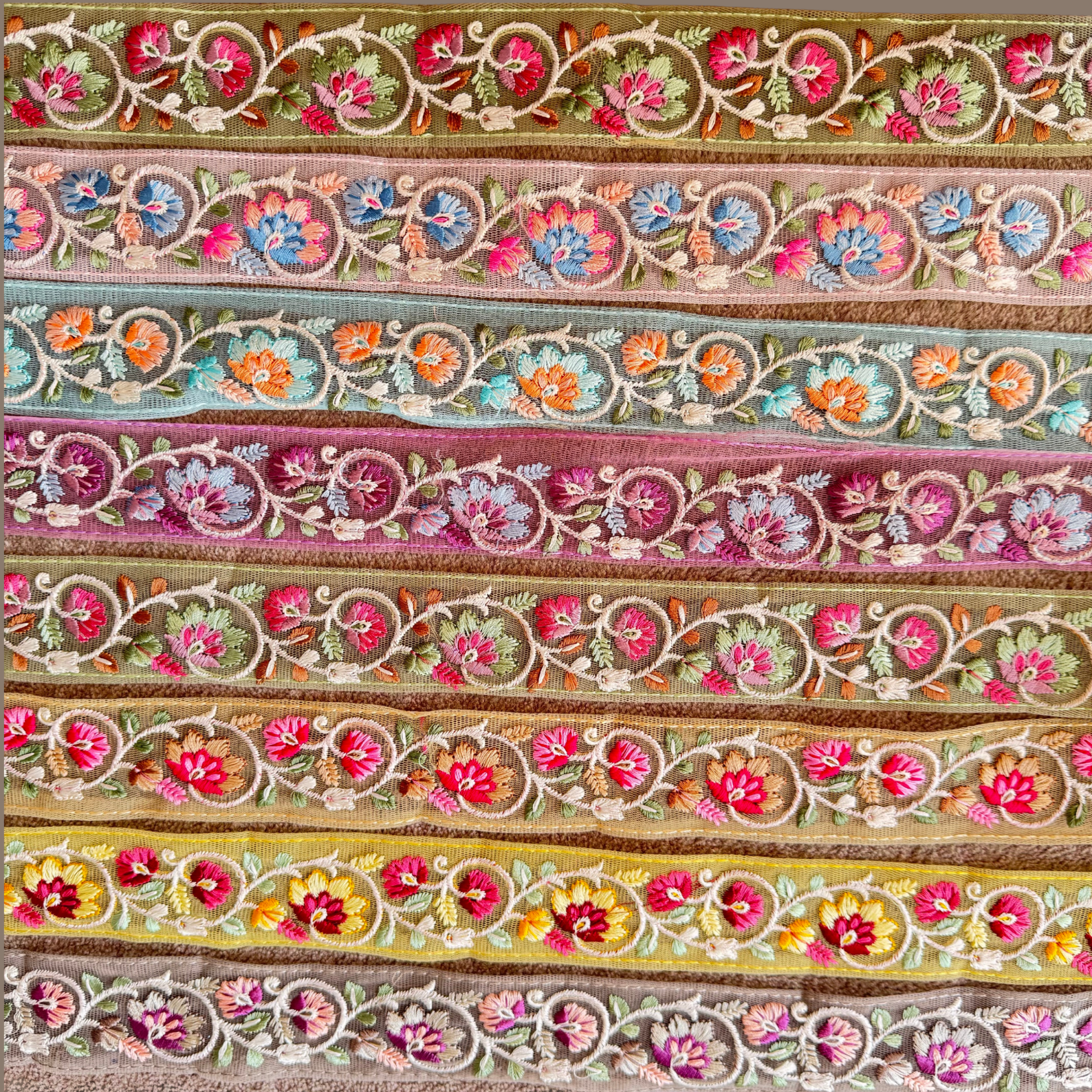 Floral Embroidered Net Trim displayed in different colours