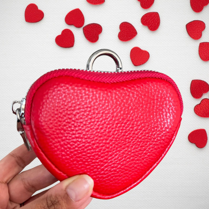 A person holding Heart coin purse keychain in red