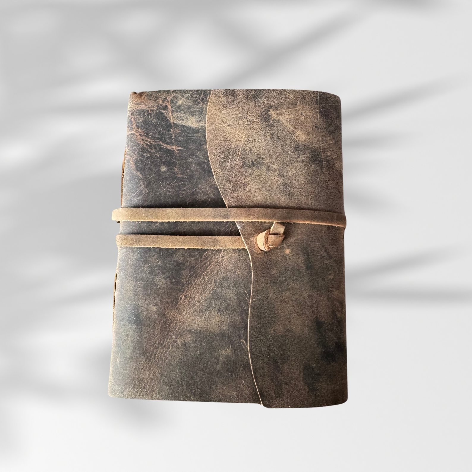 leather journal notebook on a plain white background