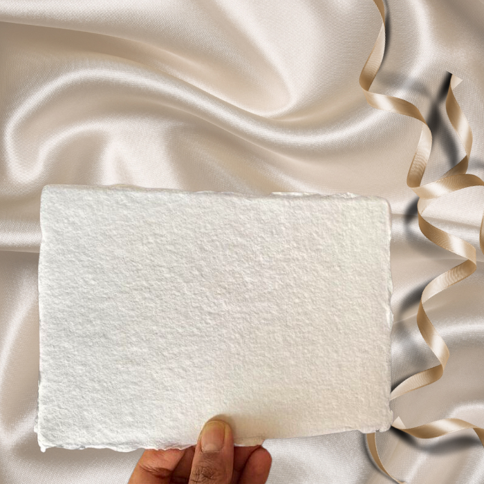 Holding 150 gsm handmade paper used for wedding invitations.