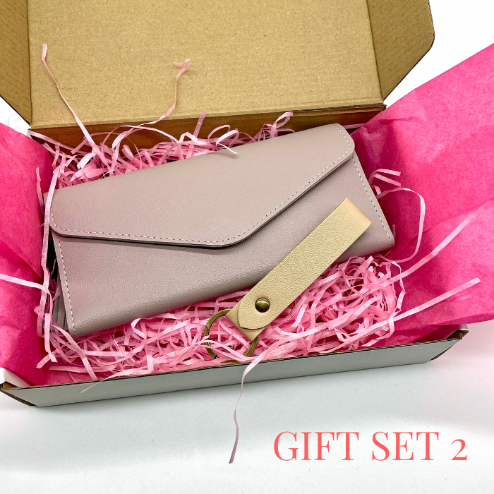 Lavender leather wallet and leather keychain beautiful packed in a gift box with pink tissue paper and tissue shreds.