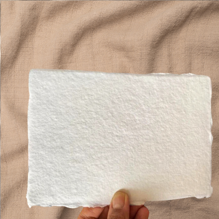 Holding a sheet of 300 GSM deckle edge paper