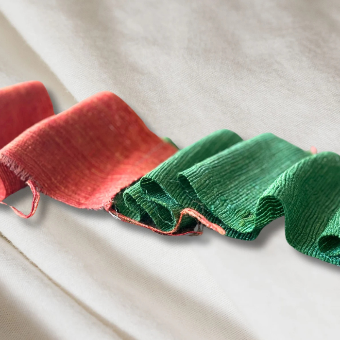 a roll  of Recycled Silk Noil Ribbon in red and green
