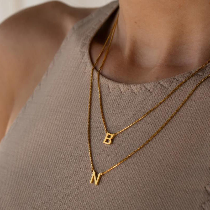 Delaney custom necklace with initial in gold with letter B  and N