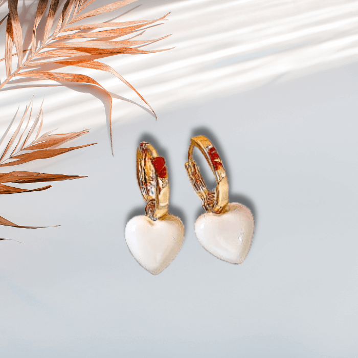 Alba Love White Dangle Earrings on a light background