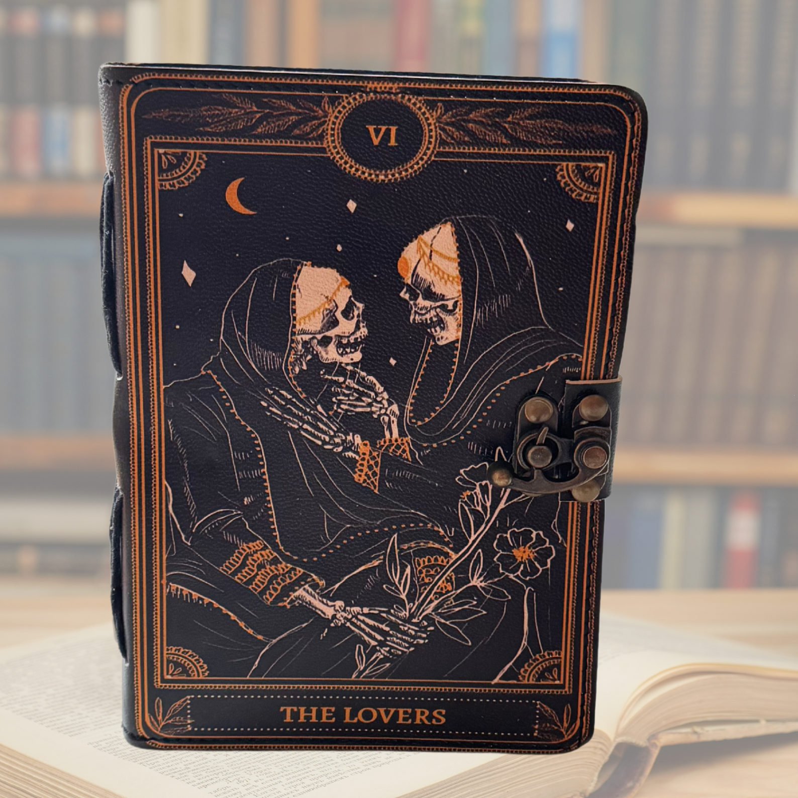 Embossed leather journal on a light background with a book library