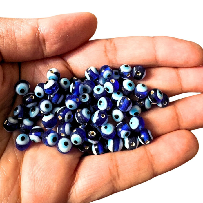 Person holding some evil eye beads also called Lampwork Beads