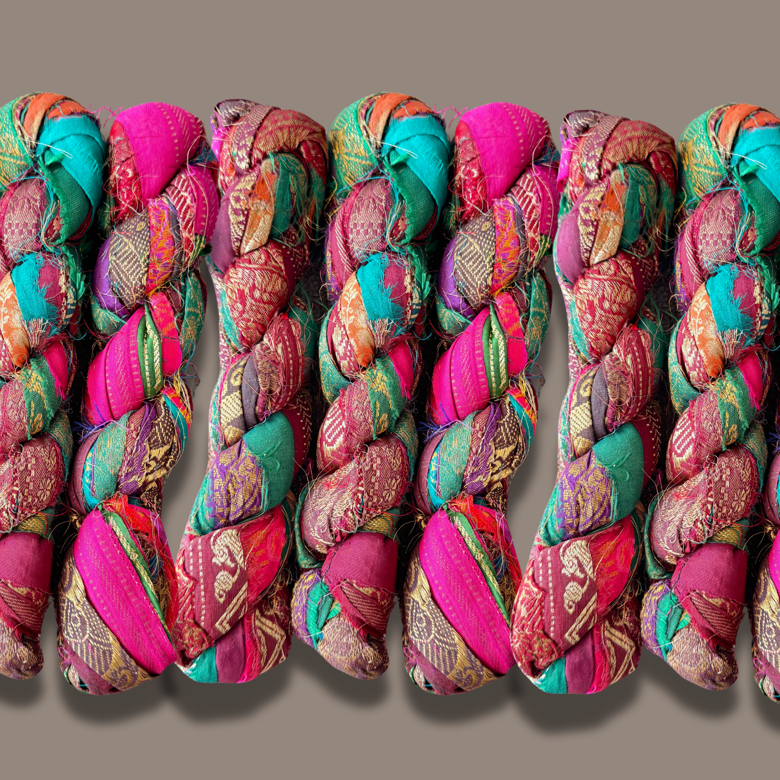 Recycled Bohemian silk fabric Ribbon on a grey background 