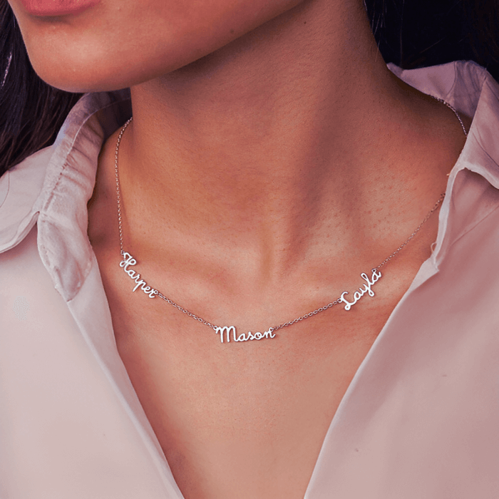 A woman wearing custom necklace Australia on silver with 3 names