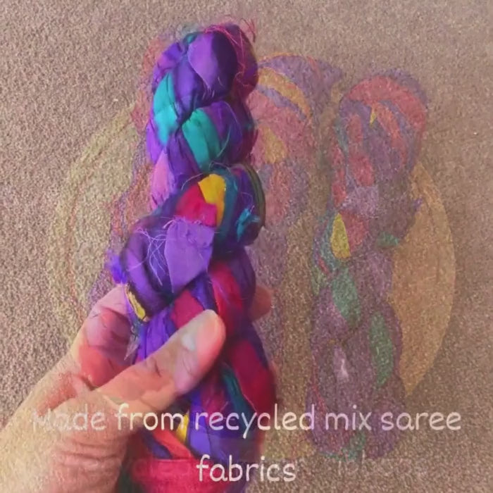 video showing a roll of multi colour Recycled Silk Sari Ribbons  Recycled Silk Sari Ribbons mix jewel tones