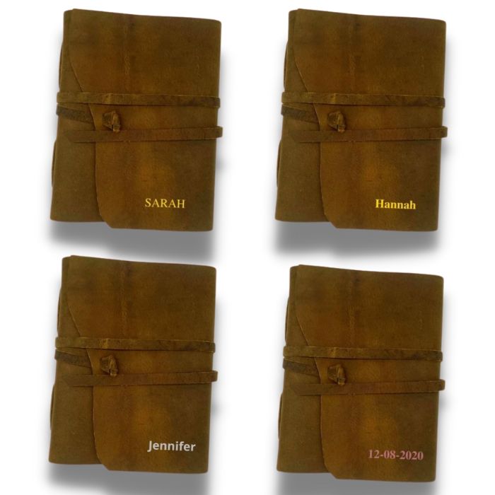 4 Brown leather journal with leather strap and personalisation on them