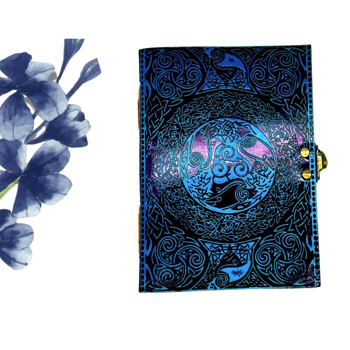 Ezra Blue leather notepad on white background with blue flowers on the side