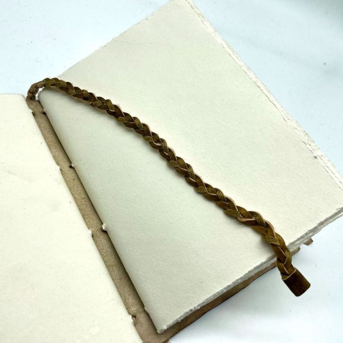 Close up of Adoria Valentine Journal plated leather bookmark and deckle edge handmade paper