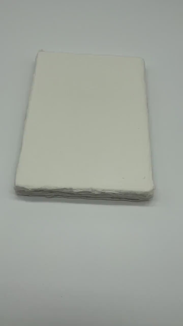 Video showing close up of 300 gsm handmade paper also called cotton rag paper with deckled edge